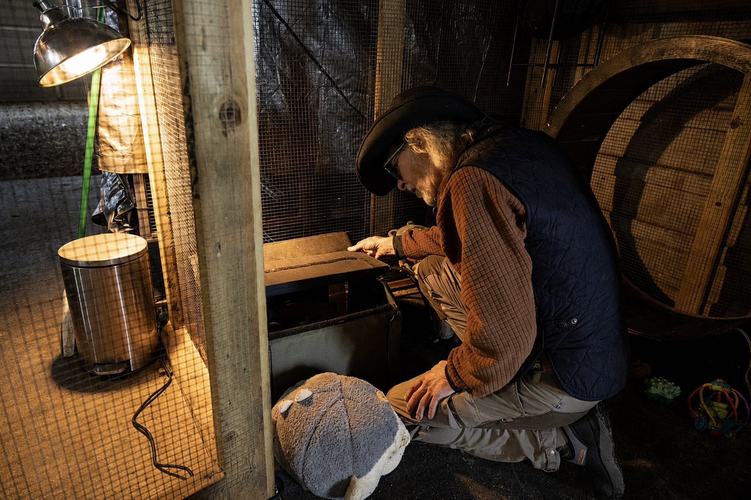 Todd tending a rescued animal enclosure by lamplight