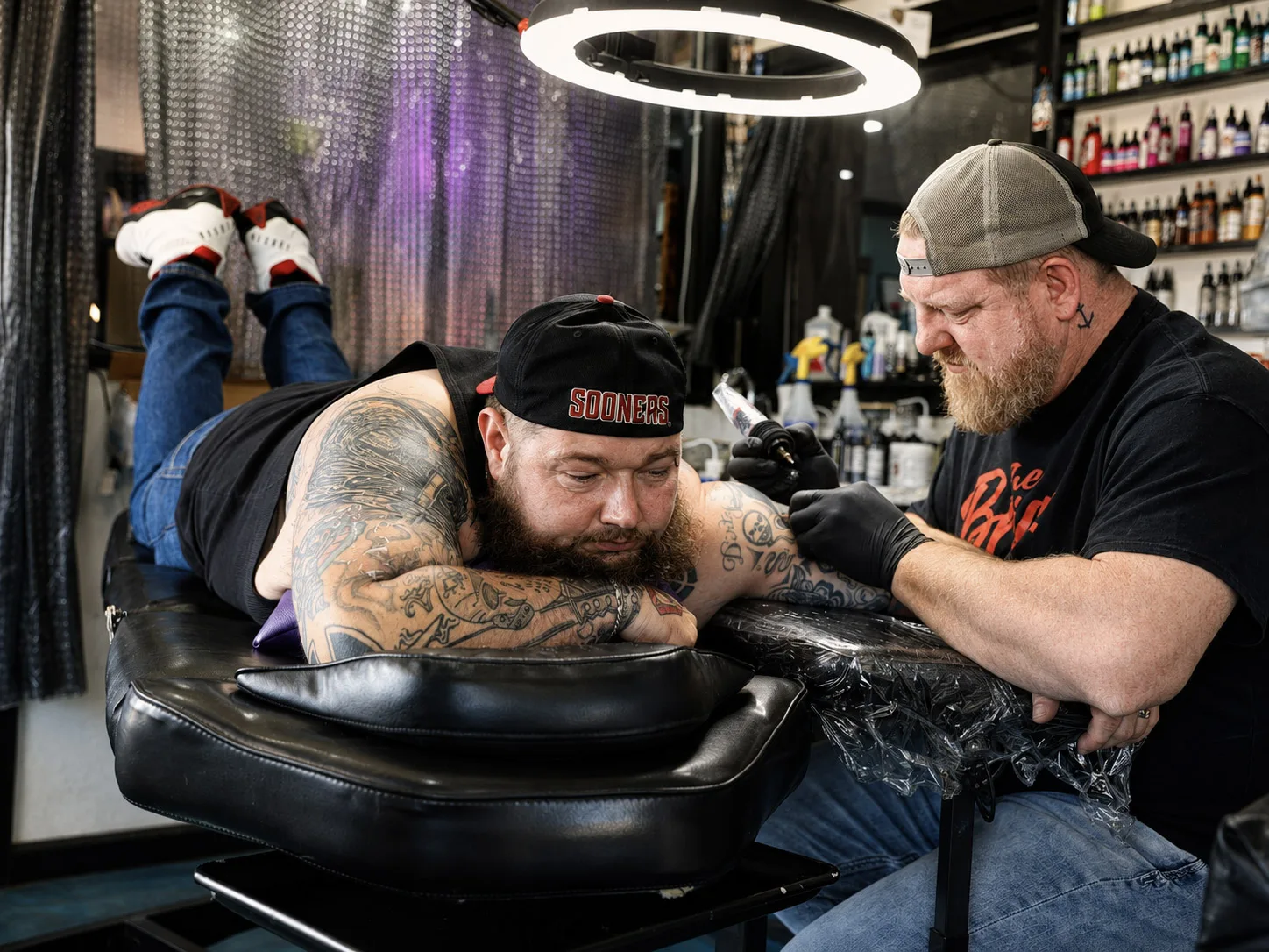 A tattoo artist covering a client's tattoo during the Stop the Hate event at a Tulsa tattoo shop