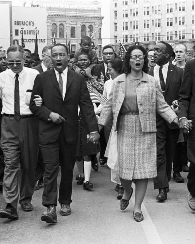 Dr. Martin Luther King Jr. and Coretta Scott King lead a crowd of civil rights marchers