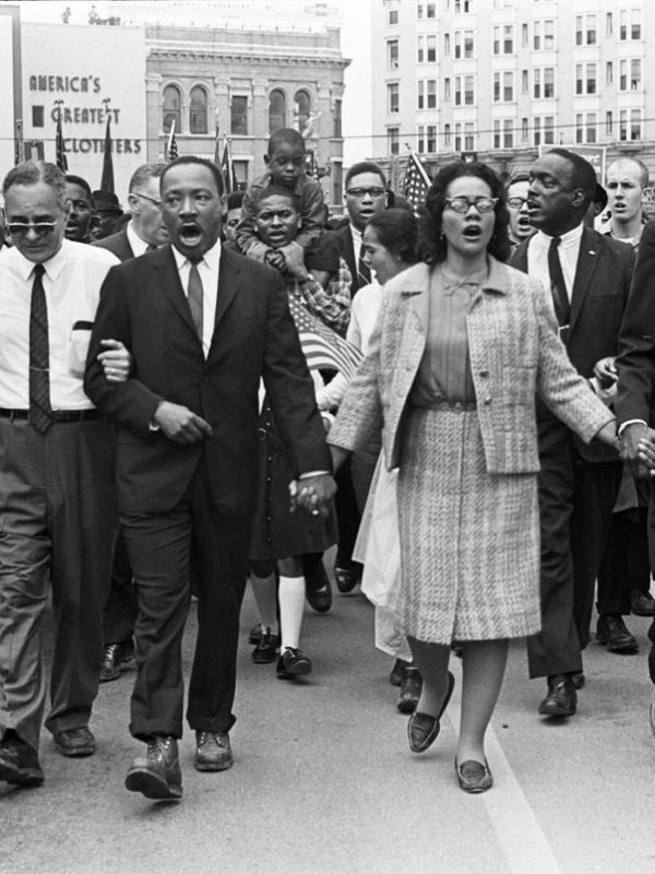 Dr. Martin Luther King Jr. and Coretta Scott King lead a crowd of civil rights marchers
