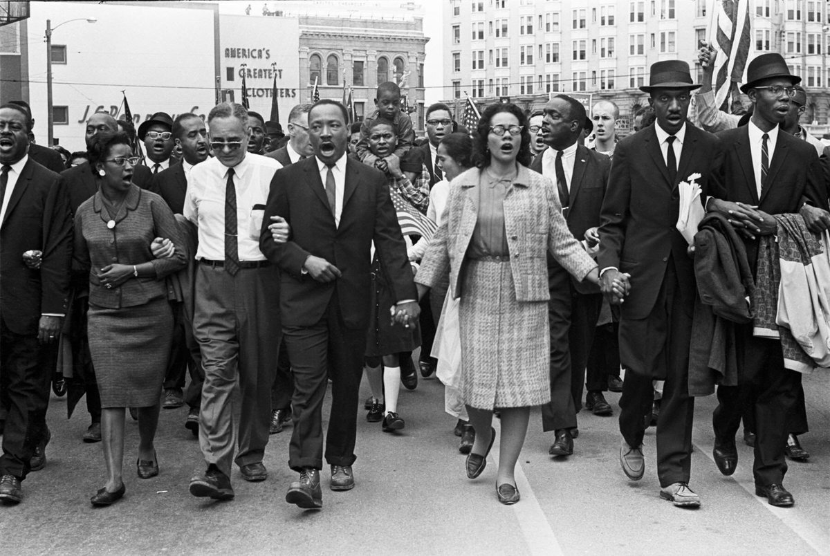 Dr. Martin Luther King Jr. and Coretta Scott King lead a crowd of civil rights marchers